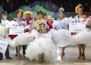 La reina con su parejo y las finalistas.
